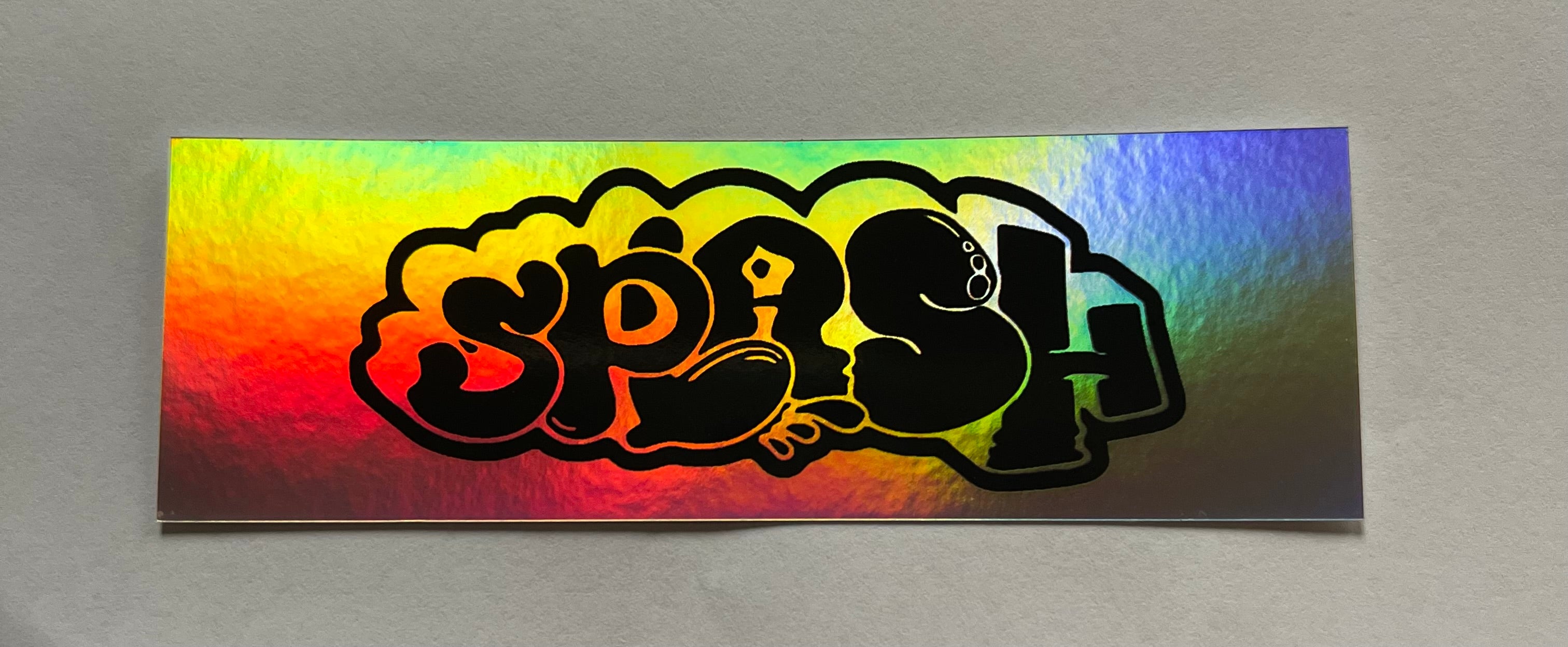 Graffiti Splash Tag Black ink on Mixed vinyl: half Silver Foil half Holographic
4.25 x 1.38" Rectangle Sticker