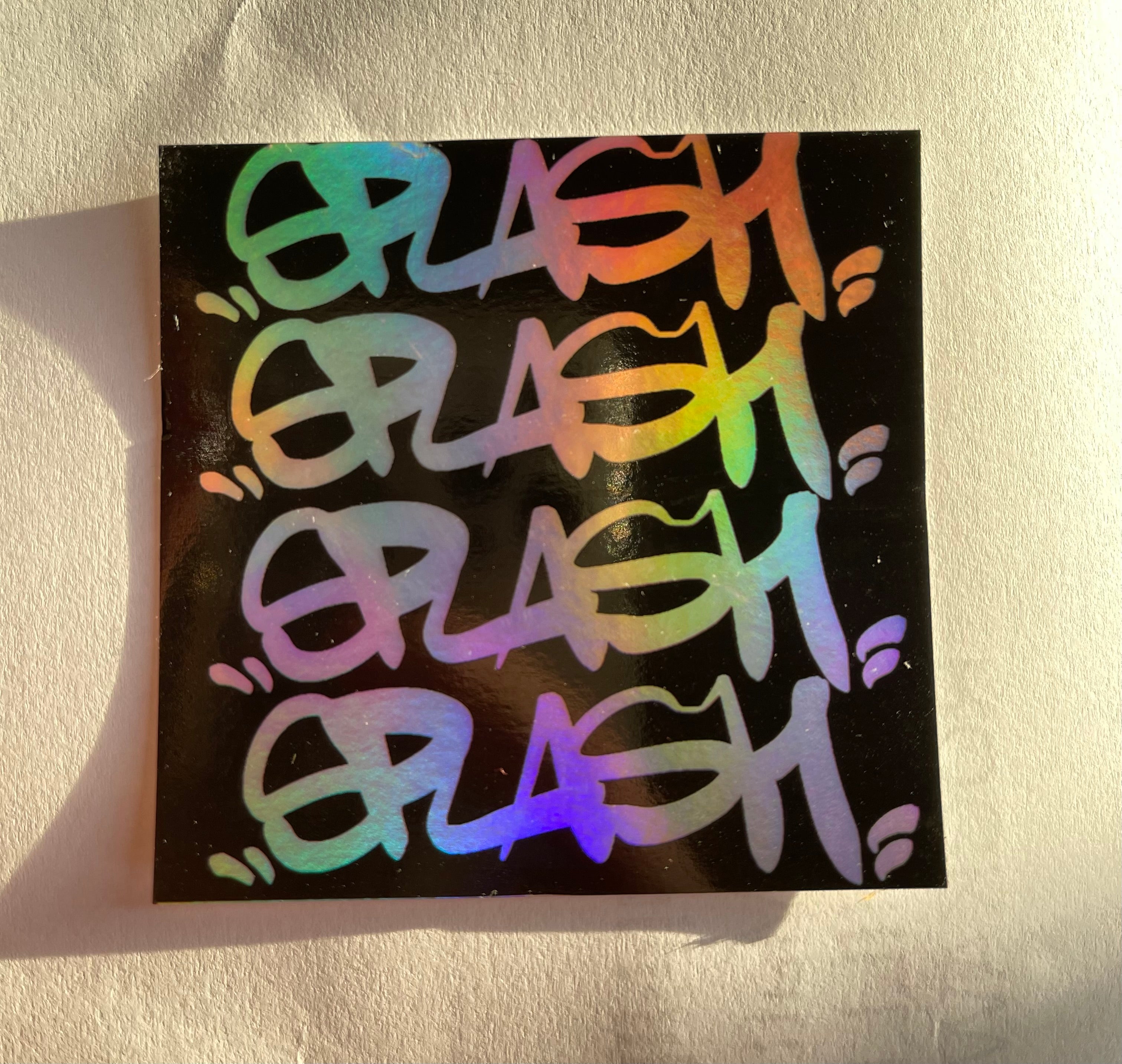 Graffiti Splash Tag Black ink on Mixed vinyl: half Silver Foil half Holographic
2.75 x 2.75" Square Sticker
