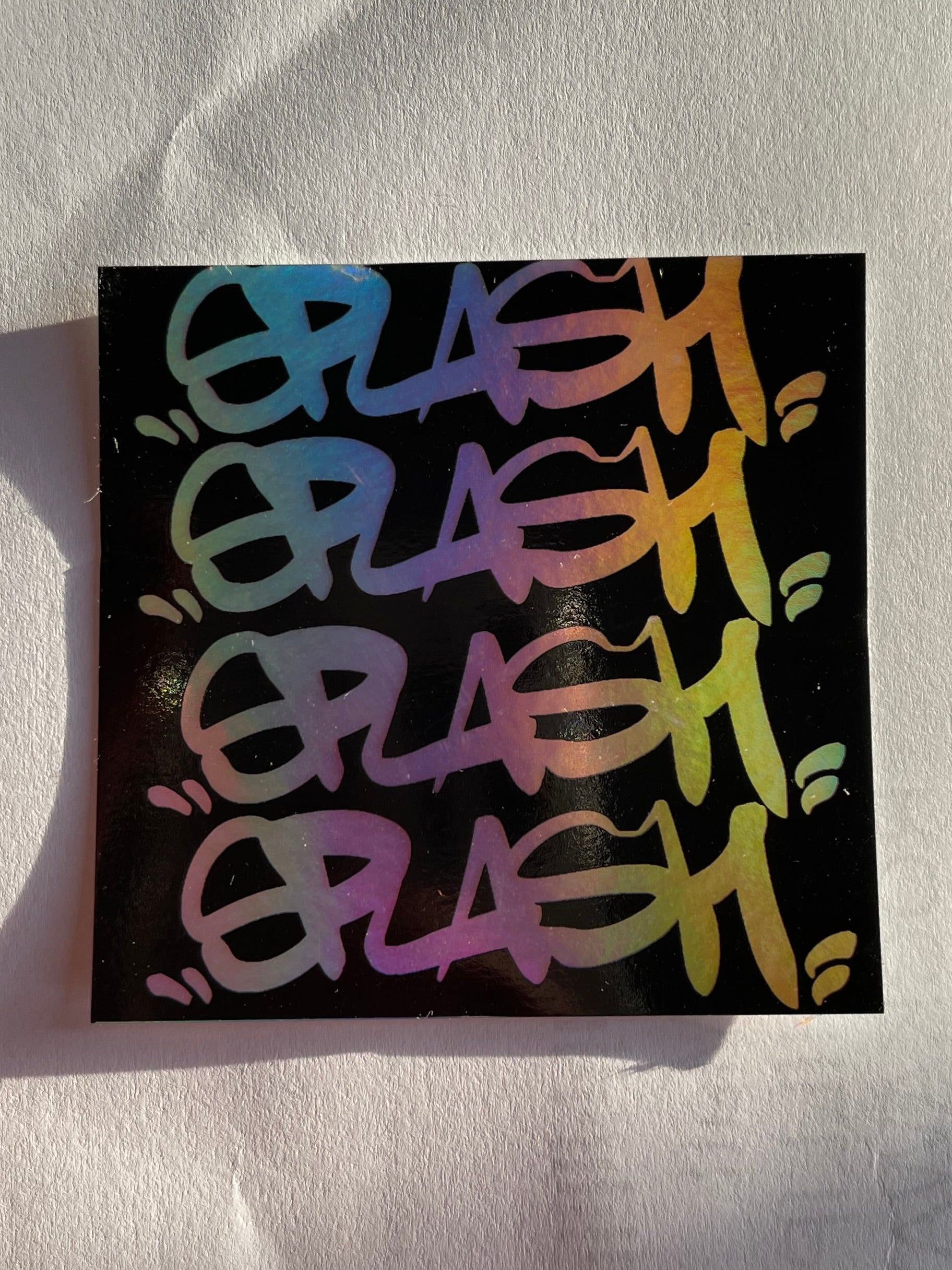 Graffiti Splash Tag Black ink on Mixed vinyl: half Silver Foil half Holographic
2.75 x 2.75" Square Sticker