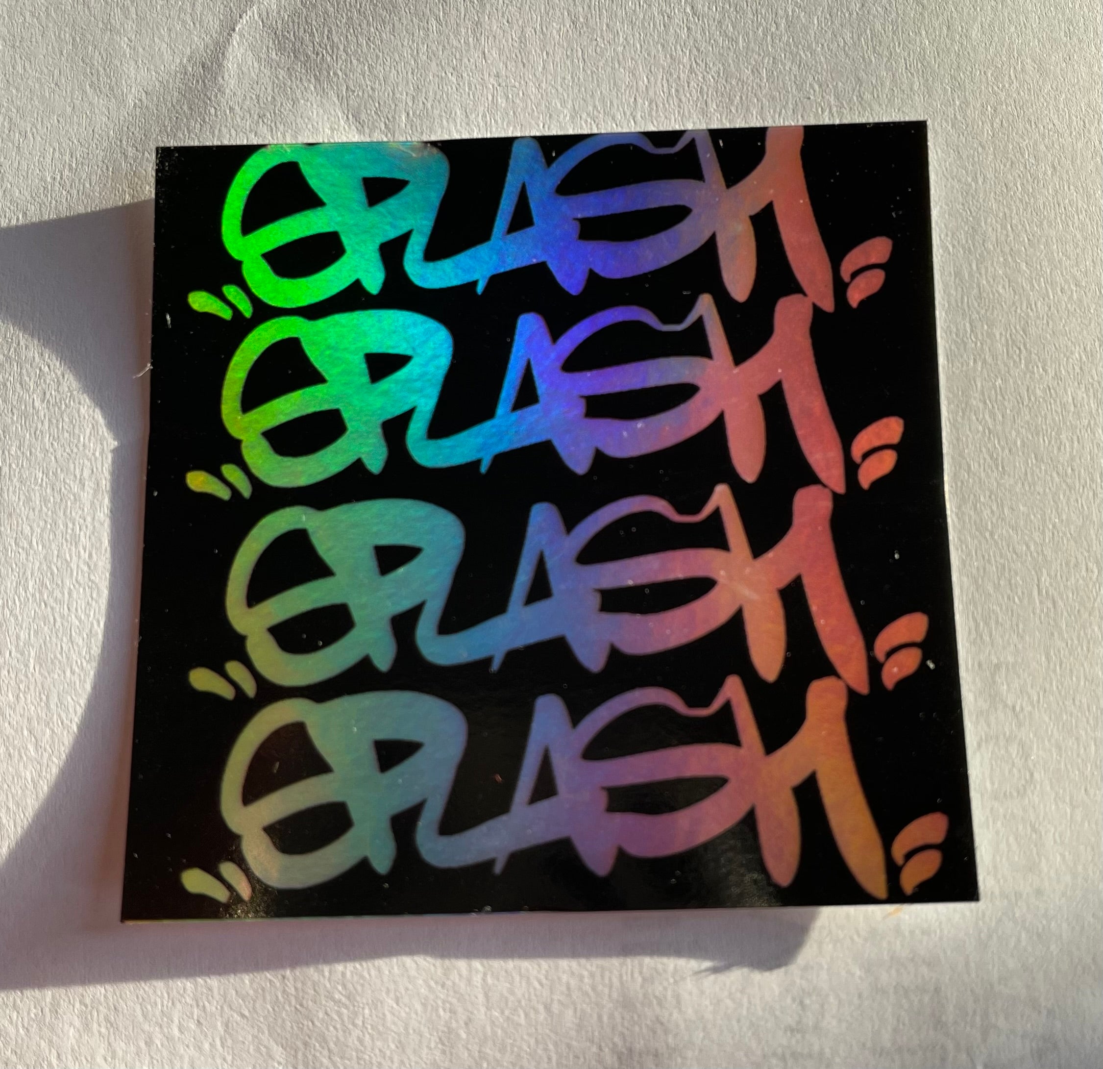 Graffiti Splash Tag Black ink on Mixed vinyl: half Silver Foil half Holographic
2.75 x 2.75" Square Sticker